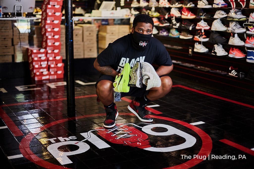 owner of the Plug shoes in Reading, PA showcases product in PPE