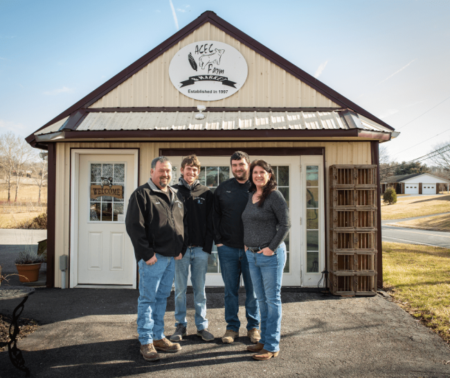 Kamp family posing in front of the ACEC Farm & Market.
