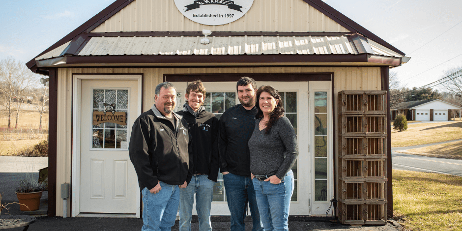 Untitled design – 2023-02-28T095834.167 Kamp family posing in front of the ACEC Farm & Market.